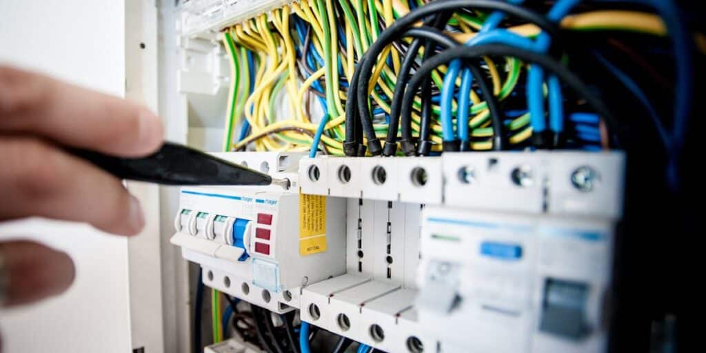 Electrical panel with circuit breakers and wiring being inspected
