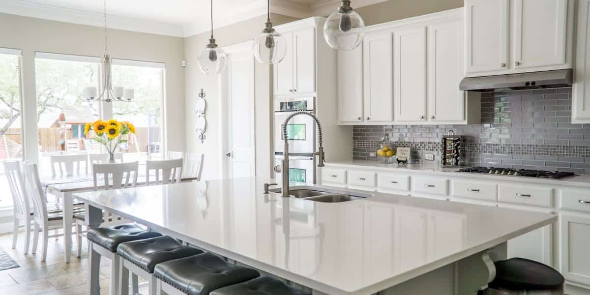 Bright professionally staged kitchen with white cabinets and modern finishes