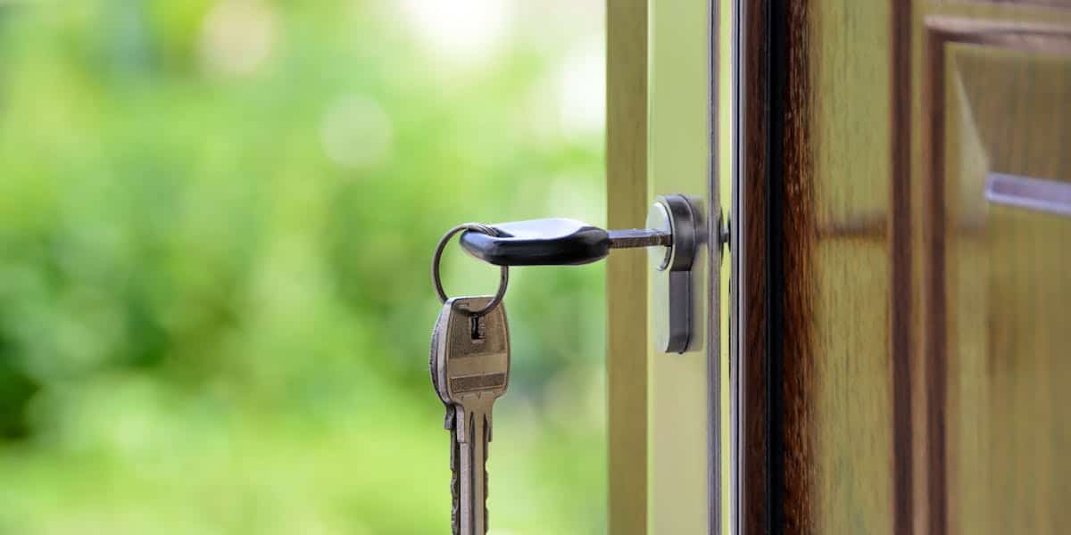 House key in door representing closing process protection through buyer representation