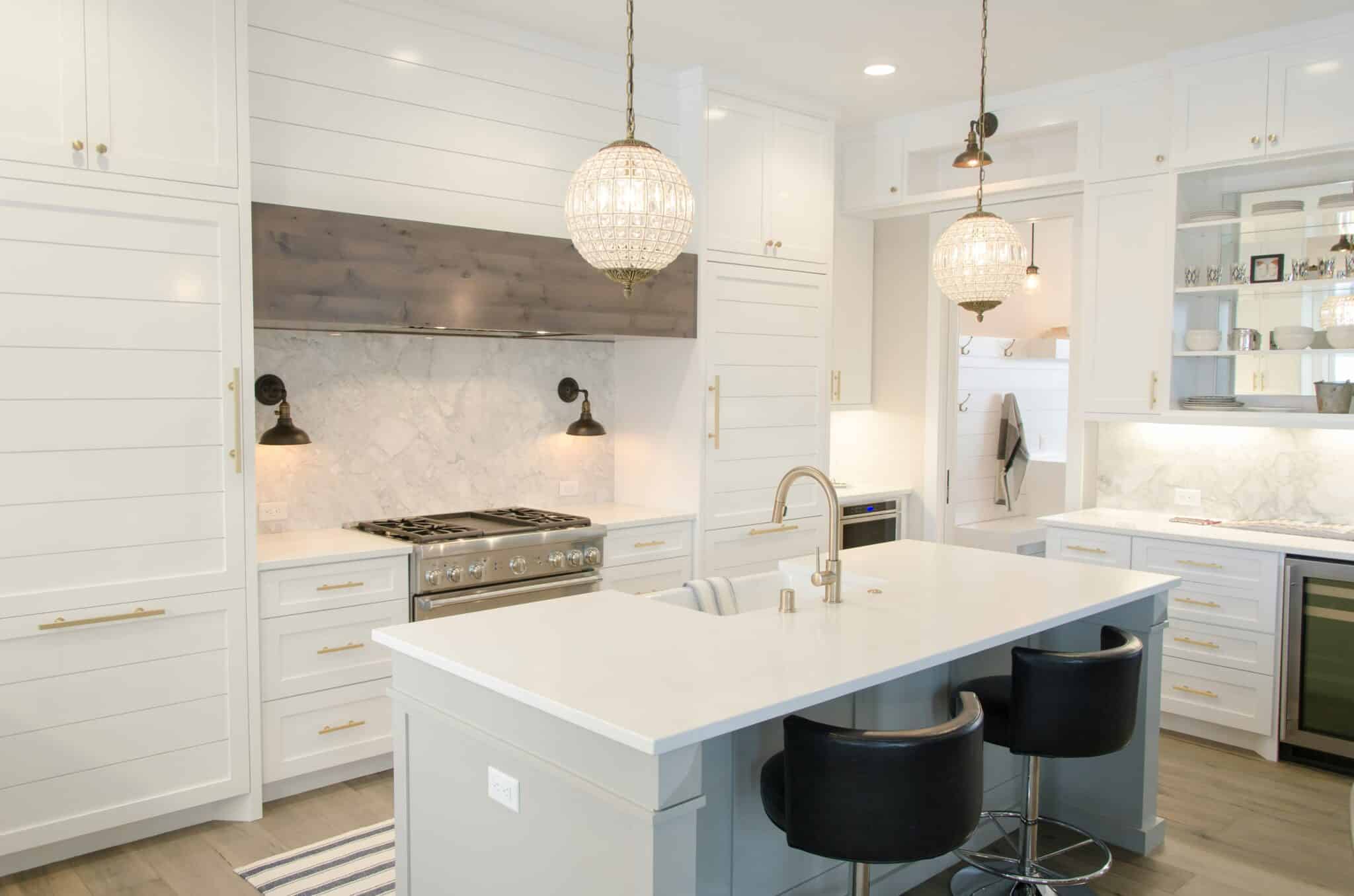 Bright white kitchen with island, pendant lights, and clean countertops