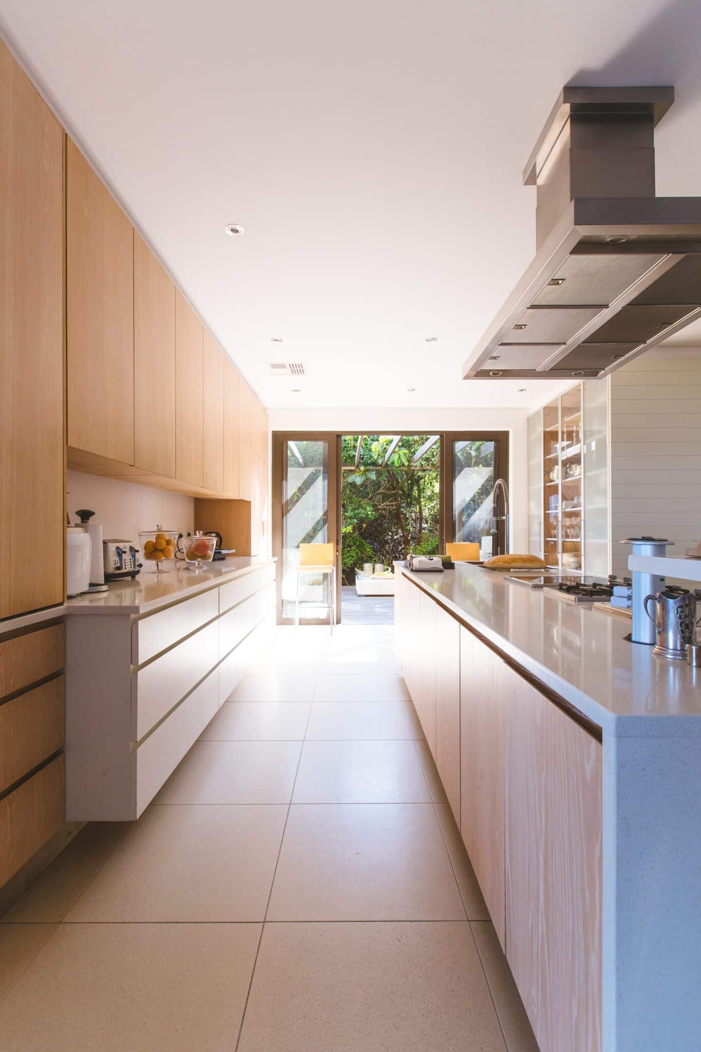 Modern kitchen with natural wood cabinets and a view to the garden